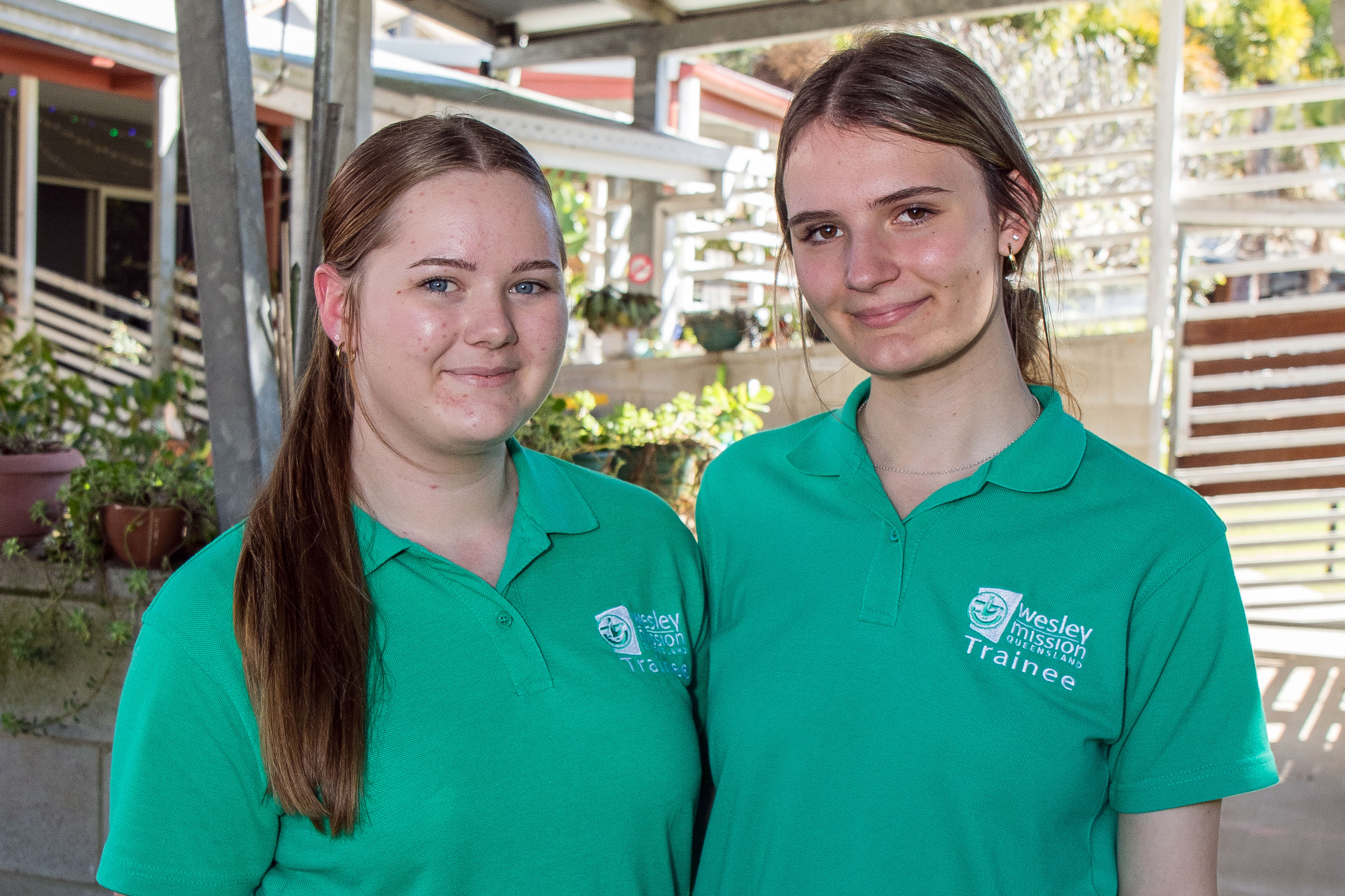 Aged care traineeship students smiling at the camera.