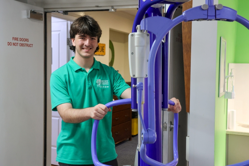 Trainee smiling, holding equipment