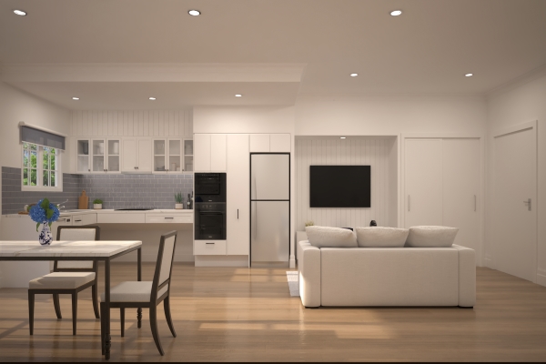 A combined kitchen and living room area including a table with two chairs and a white couch.