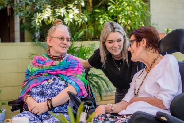 Specialist Disability Accommodation Wesley Mission Queensland Staff talking to two retirees in one of our specialist disability apartments in Brisbane