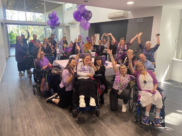 WesleyCare Sinnamon residents celebrating in purple