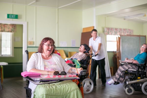 WesleyCare disability apartment residents in wheelchairs playing a game
