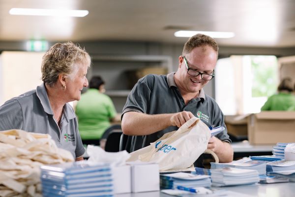 Wesley Industries disability workers packaging items for our mail service