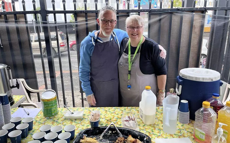 Volunteers Vince and Denise assisting at the Brisbane Relief Hub's Community Breakfast