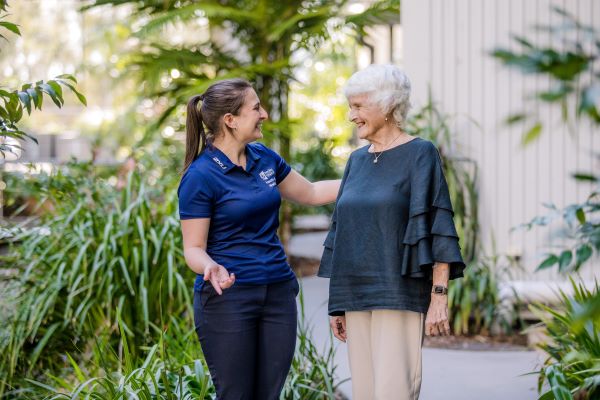 Allied Health worker taking to a retiree in one of our gardens
