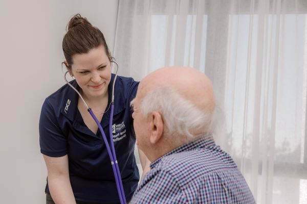 Nurse checks patient with stethoscope