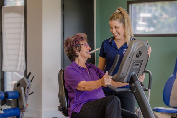 Personal trainer with a retiree at the gym in one of our residential aged care communities in Brisbane