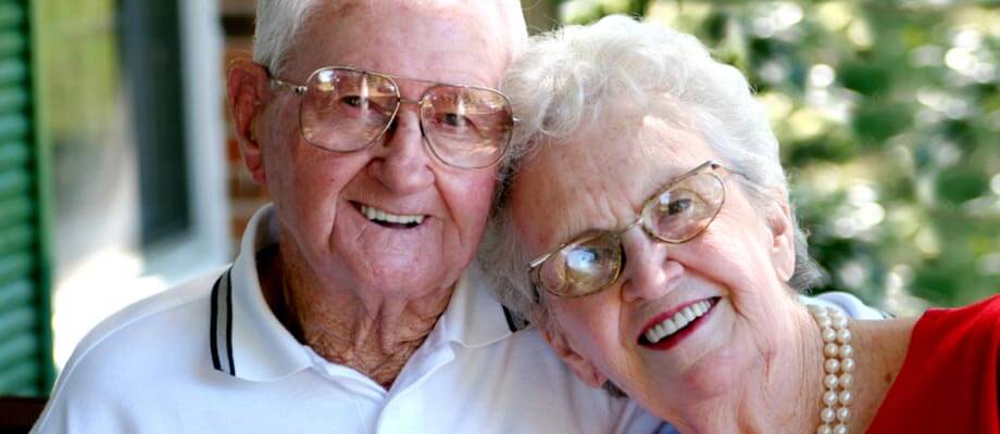 Two elderly people smiling