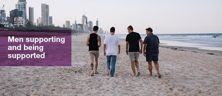 Men at the beach, with text 'Men supporting and being supported'