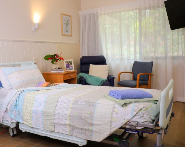 A bedroom with two sitting chairs
