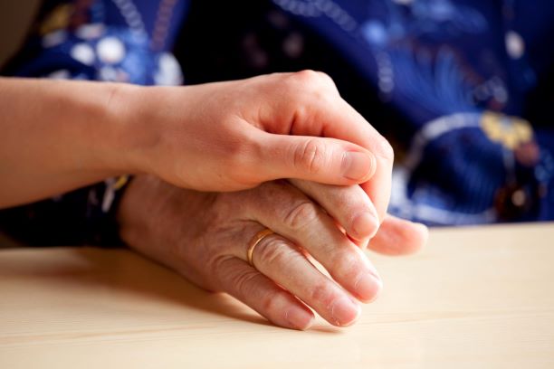 Living Well Respite residents holding hands