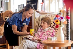 Staff member giving resident a cup of tea