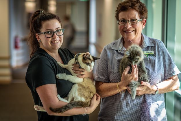 Dovetree RAC staff holding resident pet cats, their Eden philosophy companions