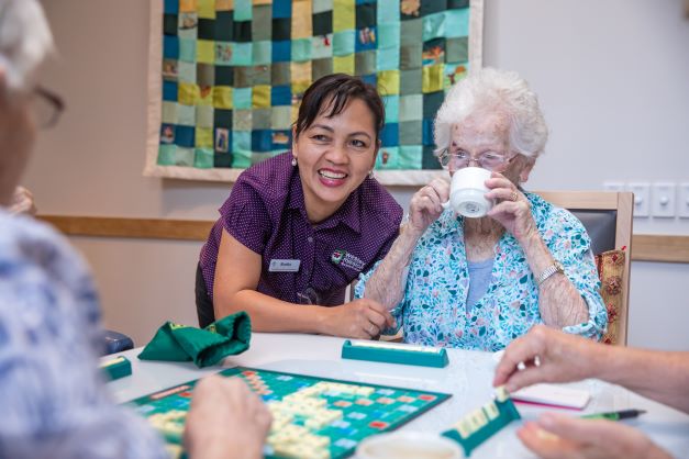 Resident enjoying game of scrabble in one of our residential aged care communities in Brisbane
