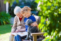 Lady reading a book with grandchild