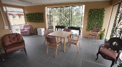 Reid Court Undercover verandah with armchairs and table