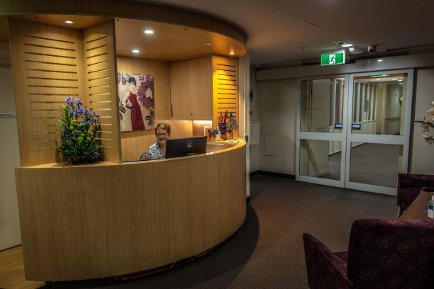 Residential admissions coordinator smiling at the reception desk