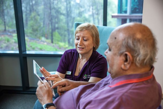 Aged care resident being shown tablet activities