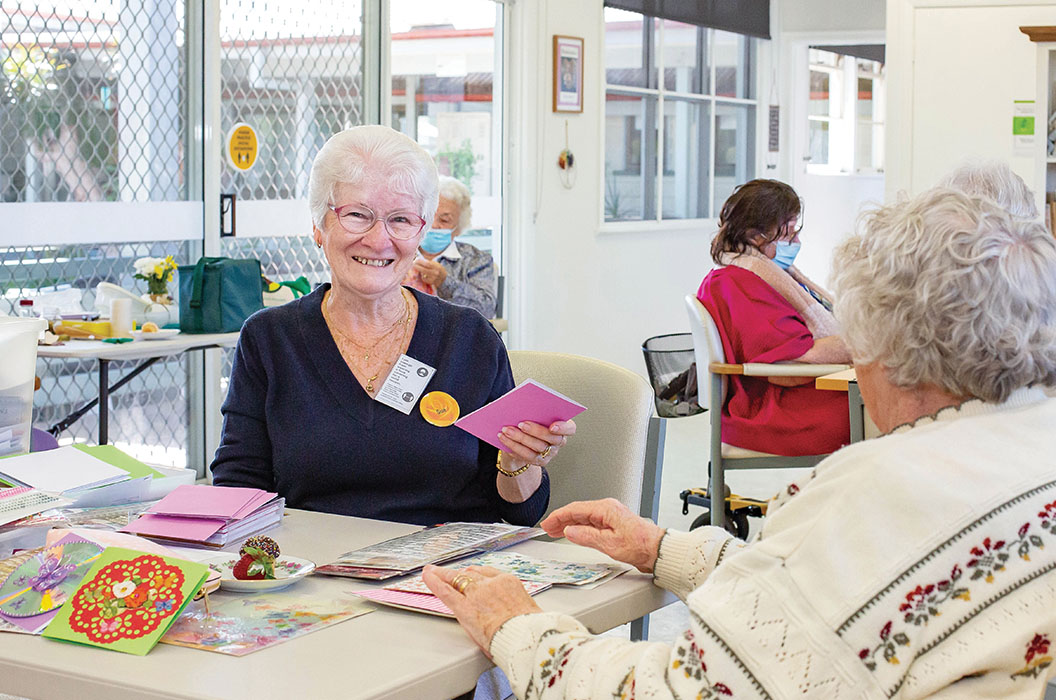 Retiree smiling during crafts at Hyland House respite care centre, in Brisbane