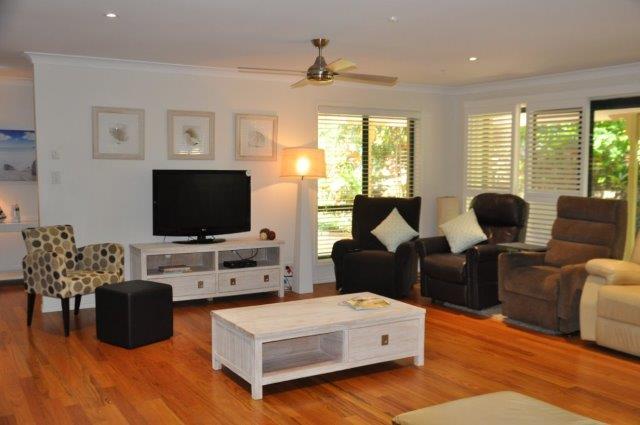 Spacious lounge area with armchairs, tv and coffee table