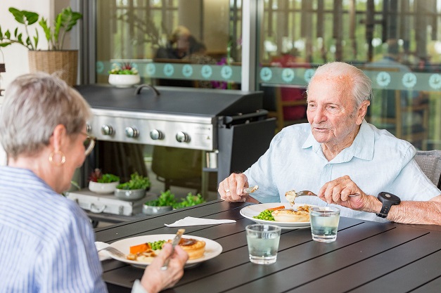 02082023_Respite_HaddenPlace_Promotional_012_resize A lady and gentlemen sitting at a table eating a light lunch