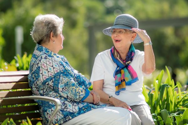 Friendly community Wheller on the Park Two residents chatting in the gardens at Wheller on the Park