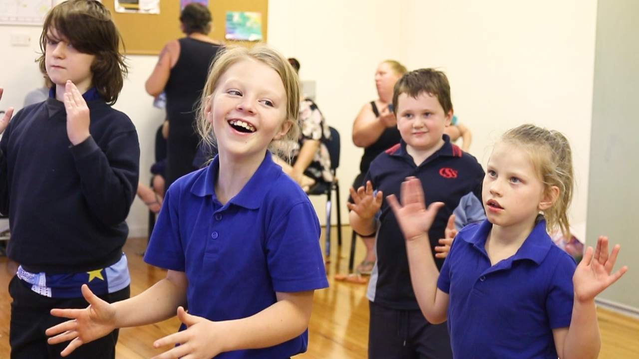 Smiling children clapping