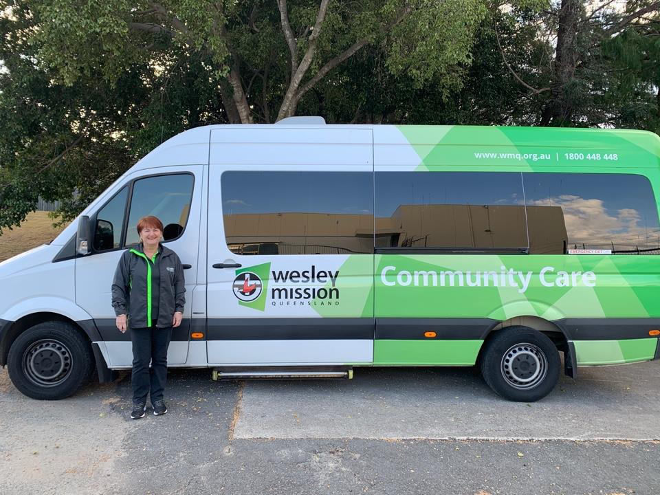 Woman standing in front of a minibus